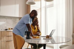 happy couple looking at a laptop together